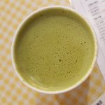 white ceramic mug with green liquid
